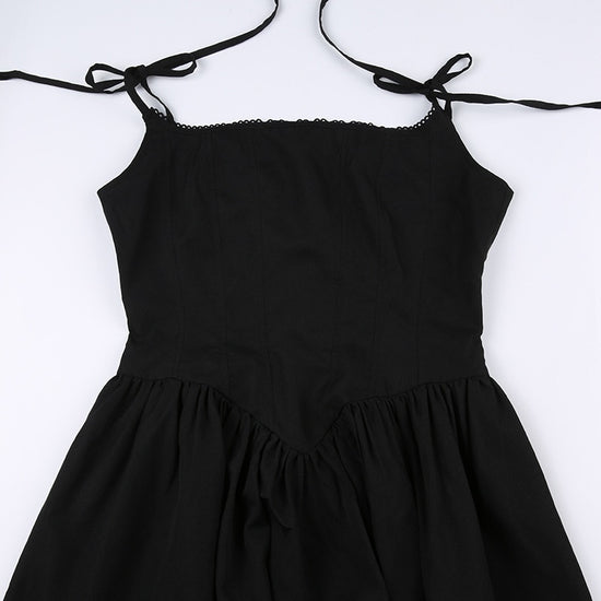 Flat lay close-up of the corset-inspired detailing and tie straps on the front of the Midnight Sonata Corset Dress.