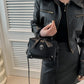 Close-up of the Moonlit Mourning Crossbody with the cross embellishment.