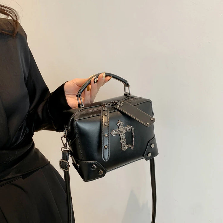 Model carrying the cross version of the Moonlit Mourning Crossbody by the top handle.