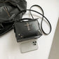 Moonlit Mourning Crossbody shown next to a smartphone for size comparison.
