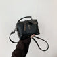 Handheld front view of the Moonlit Mourning Crossbody with the skull design.