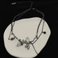 Dramatic product display of the Moonvine Dragonfly Necklace with layered chains, dragonfly-inspired details, and dark romantic styling.