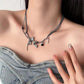 The Moonvine Dragonfly Necklace paired with a denim top for an ethereal dark-feminine look.