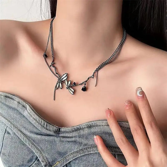 The Moonvine Dragonfly Necklace paired with a denim top for an ethereal dark-feminine look.