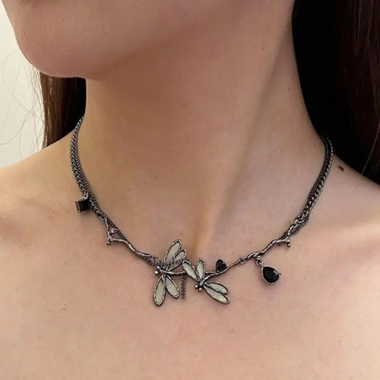 Side-angle view of the Moonvine Dragonfly Necklace featuring asymmetrical chain details and a dreamy gothic-inspired design.