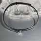 Black faux leather choker with rose centerpiece detail.
