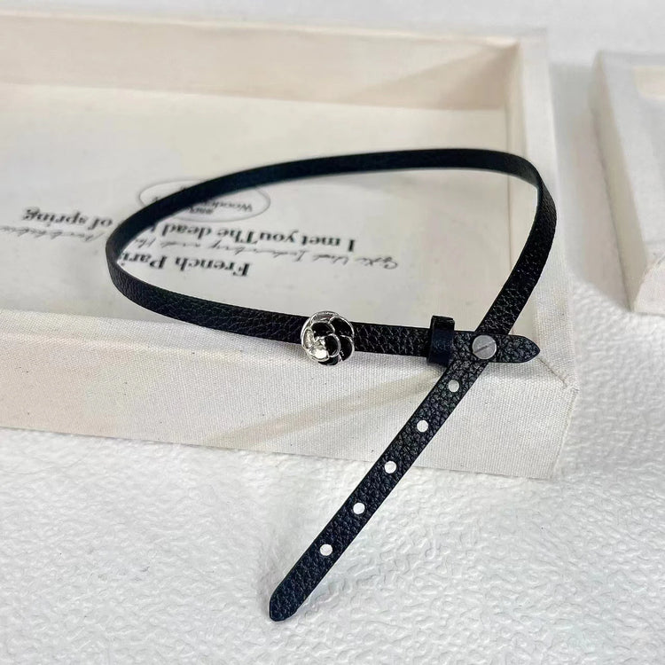 Black faux leather choker with rose centerpiece detail.