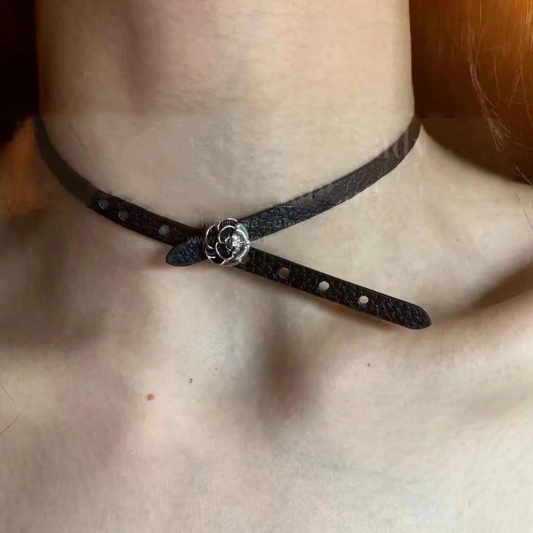 Black faux leather choker featuring a silver rose charm centerpiece.