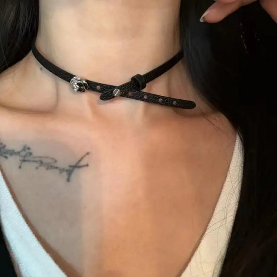 Model wearing the Obsidian Grace Rose Choker with silver rose detail on a black strap.