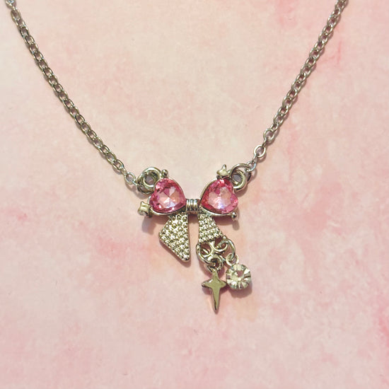 Detailed, close-up shot of Pink Crystal Bow Necklace chain and pendant connection