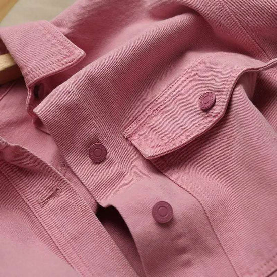 Close-up of the Pink Petal Denim Overshirt, highlighting the chest pocket and matching pink buttons.