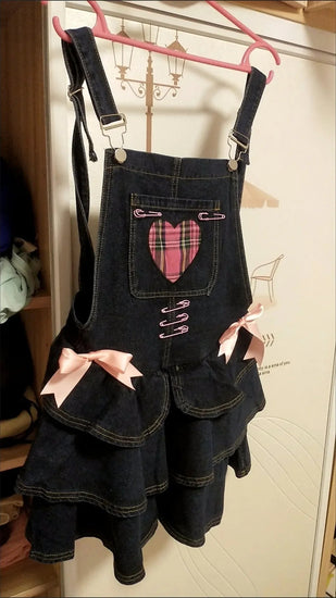 Pocket Full of Love Overall Dress hanging front view showing the plaid heart and tiered skirt