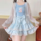 The Polka Dot Sweetie Tiered Skirt in blue, styled with a sheer cardigan and removable oversized bow pin for a dreamy kawaii look.