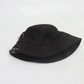 Collapsed view of the Rebel Charm Bucket Hat in black showing the clean design and structured fit.