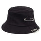 The Rebel Pin Bucket Hat in black featuring bold safety pin details on a classic bucket silhouette.