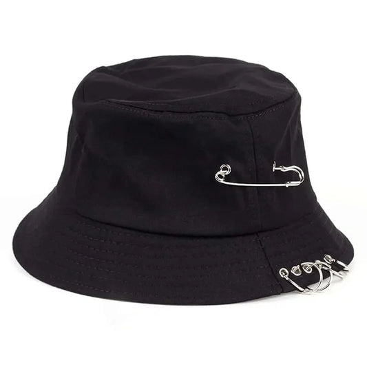 The Rebel Pin Bucket Hat in black featuring bold safety pin details on a classic bucket silhouette.