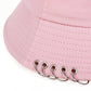 Close-up of the Rebel Pin Bucket Hat in pink focusing on the metal rings and stitching.