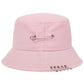 The Rebel Pin Bucket Hat in pink with safety pin accents adding a soft yet edgy aesthetic.