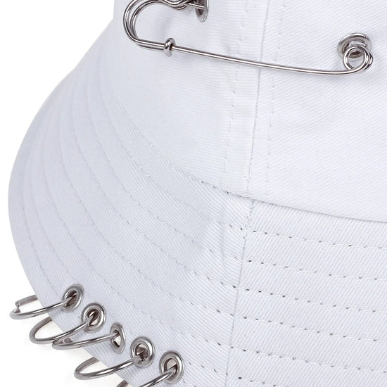 Close-up of the Rebel Pin Bucket Hat in white highlighting the safety pins and stitched brim detail.