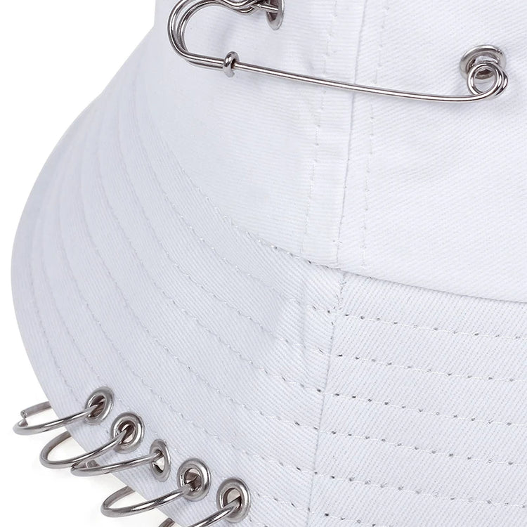 Close-up of the Rebel Pin Bucket Hat in white highlighting the safety pins and stitched brim detail.