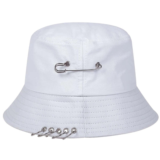 The Rebel Pin Bucket Hat in white with silver safety pin details for a clean yet edgy look.