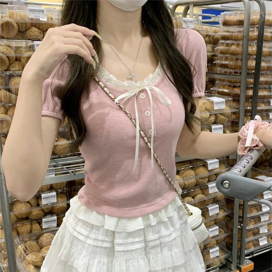 Pink Ribbon Knit Ballet Top with fine ribbed knit texture, short puff sleeves, and decorative ribbon tie at neckline