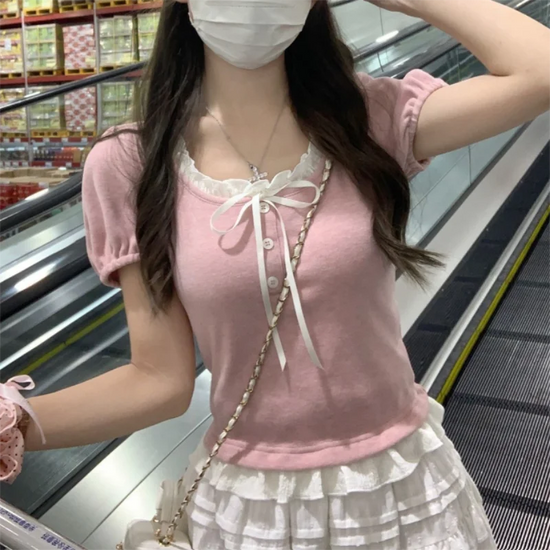 Pink Ribbon Knit Ballet Top styled with a ruffled skirt, showing fitted knit silhouette and ribbon neckline detail