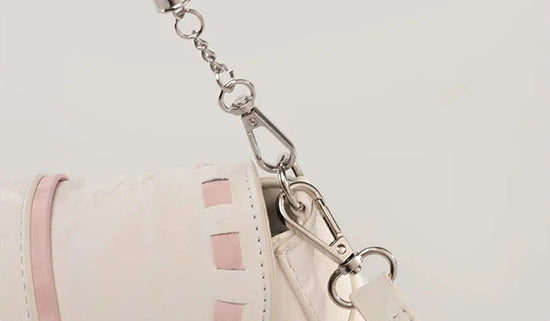 Close-up of the Ribbon Romance Shoulder Bag in cream, highlighting the detachable shoulder straps and interwoven ribbon detailing.