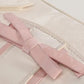Close-up of the Ribbon Romance Shoulder Bag, highlighting the statement ribbon bow and interwoven ribbon detailing.