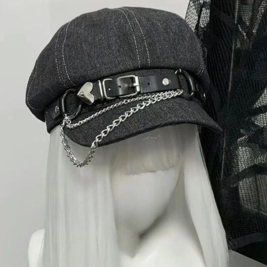Close-up of Rogue Chain Newsboy Cap silver chain and heart buckle strap detail