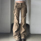 Closer view of the front of the Rogue Revival Utility Pants with strap accents and flared hem
