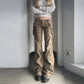 Model wearing Rogue Revival Utility Pants with a light gray sweatshirt and chunky brown shoes