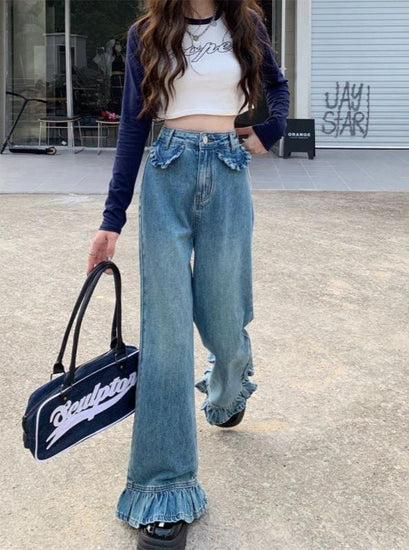 Model walking in Ruffle Flare Jeans showing movement and dramatic ruffle detail
