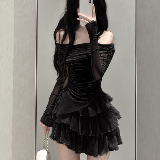 Ruffle Love Two-Piece Set in black modeled in a mirror selfie, featuring a fitted off-shoulder long-sleeve top and matching layered ruffle mini skort.