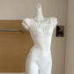 White Ruffled Romance Top displayed on a mannequin with a lace-trimmed square neckline, ribbon ties, gathered bust, and ruffled puff sleeves.