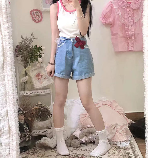 Full-body image of a model showing how the Scarlet Sweetheart High-Rise Shorts pair with frilly socks and a casual tank