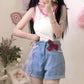 Scarlet Sweetheart High-Rise Shorts styled in a soft aesthetic on model, featuring light blue denim, high-waisted fit, red bow, and lace trim pockets