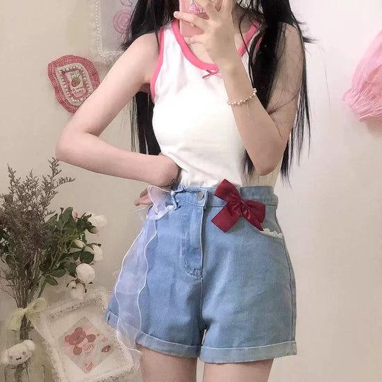 Scarlet Sweetheart High-Rise Shorts styled in a soft aesthetic on model, featuring light blue denim, high-waisted fit, red bow, and lace trim pockets
