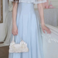 The front of the Seraphina Lace Midi Dress displayed on a model, showing the lace capelet and flowing blue skirt.