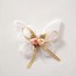 Close-up of lace butterfly appliqué with floral accent and bow on the Serene Butterfly Crop Top