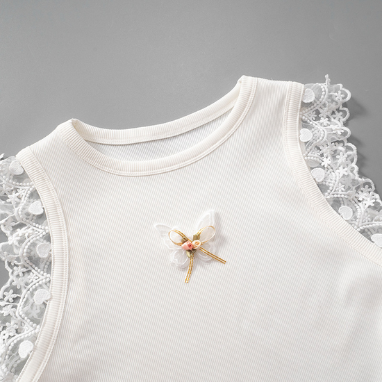 Angled flat lay of the top half of the Serene Butterfly Crop Top with butterfly appliqué, bow, and lace trim