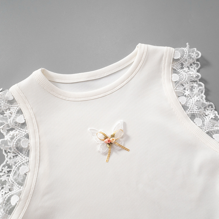 Angled flat lay of the top half of the Serene Butterfly Crop Top with butterfly appliqué, bow, and lace trim