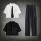 The Shadow Chain Utility Set featuring short-sleeve cropped button-up shirts available in black or white with matching black ties, removable safety pins with chain details, adjustable drawstring waists, and black utility pants with detachable chains, cargo pockets, and adjustable drawstring hems.