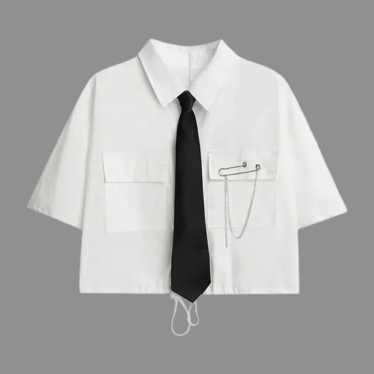 White short-sleeve cropped button-up shirt from the Shadow Chain Utility Set featuring a matching black tie, removable safety pin with chain, and adjustable drawstring waist.