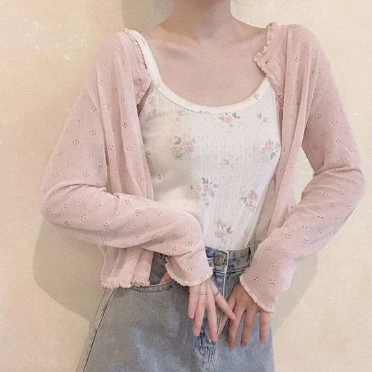 Model wearing the Sheer Sweetness Cardigan in blush pink layered over a floral cami