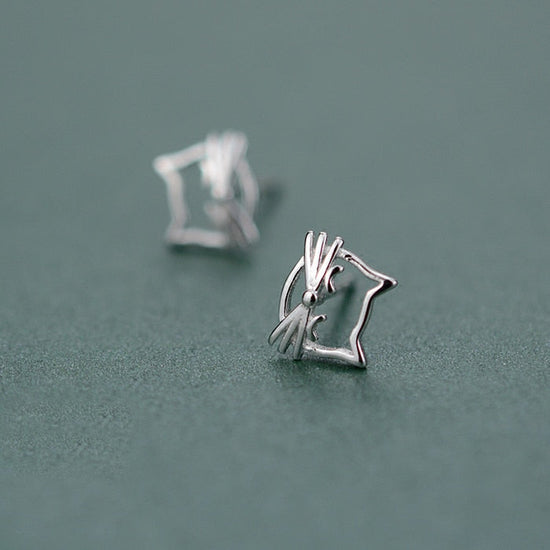 Side-angle view of the Silver Kitty Stud Earrings, highlighting the open-outline cat design.