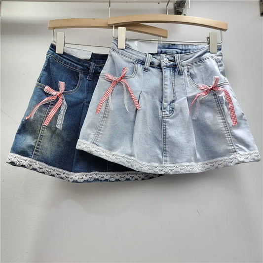 Southern Charm Mini Skort in light and dark denim with red gingham and white lace bows on pockets and lace-trim hem, front view