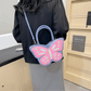 Blue and pink Sparkling Butterfly Handbag worn crossbody the back of a model