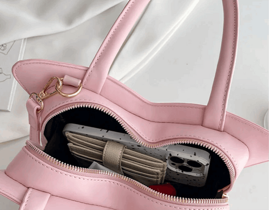 Close-up of interior zipper compartment of Sparkling Butterfly Handbag in pink and white