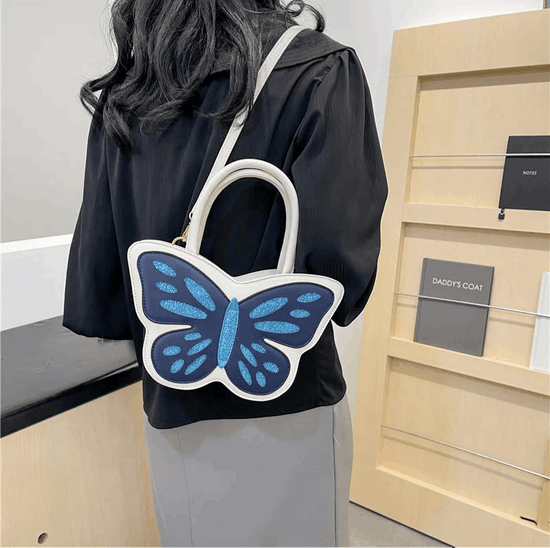 Model wearing Sparkling Butterfly Handbag in white and blue behind their back